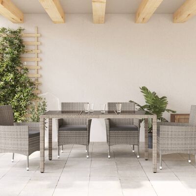 vidaXL Tuintafel met glazen blad 150x90x75 cm poly rattan grijs