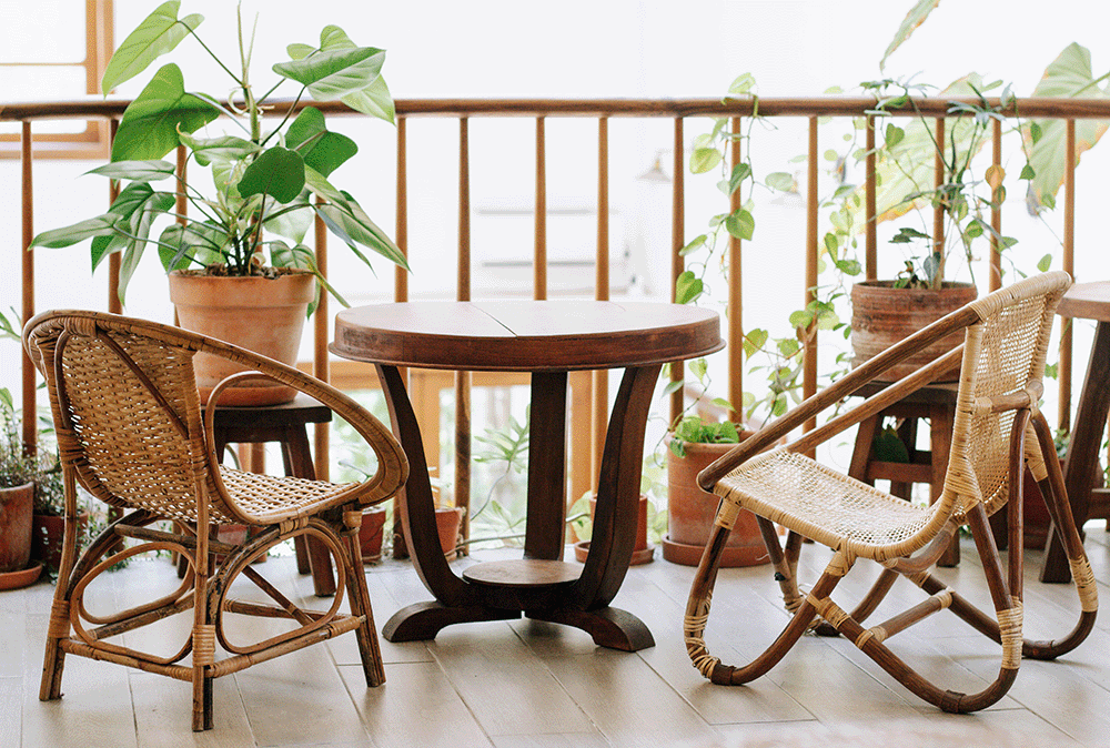 botanical balcony with rattan chairs and wooden table